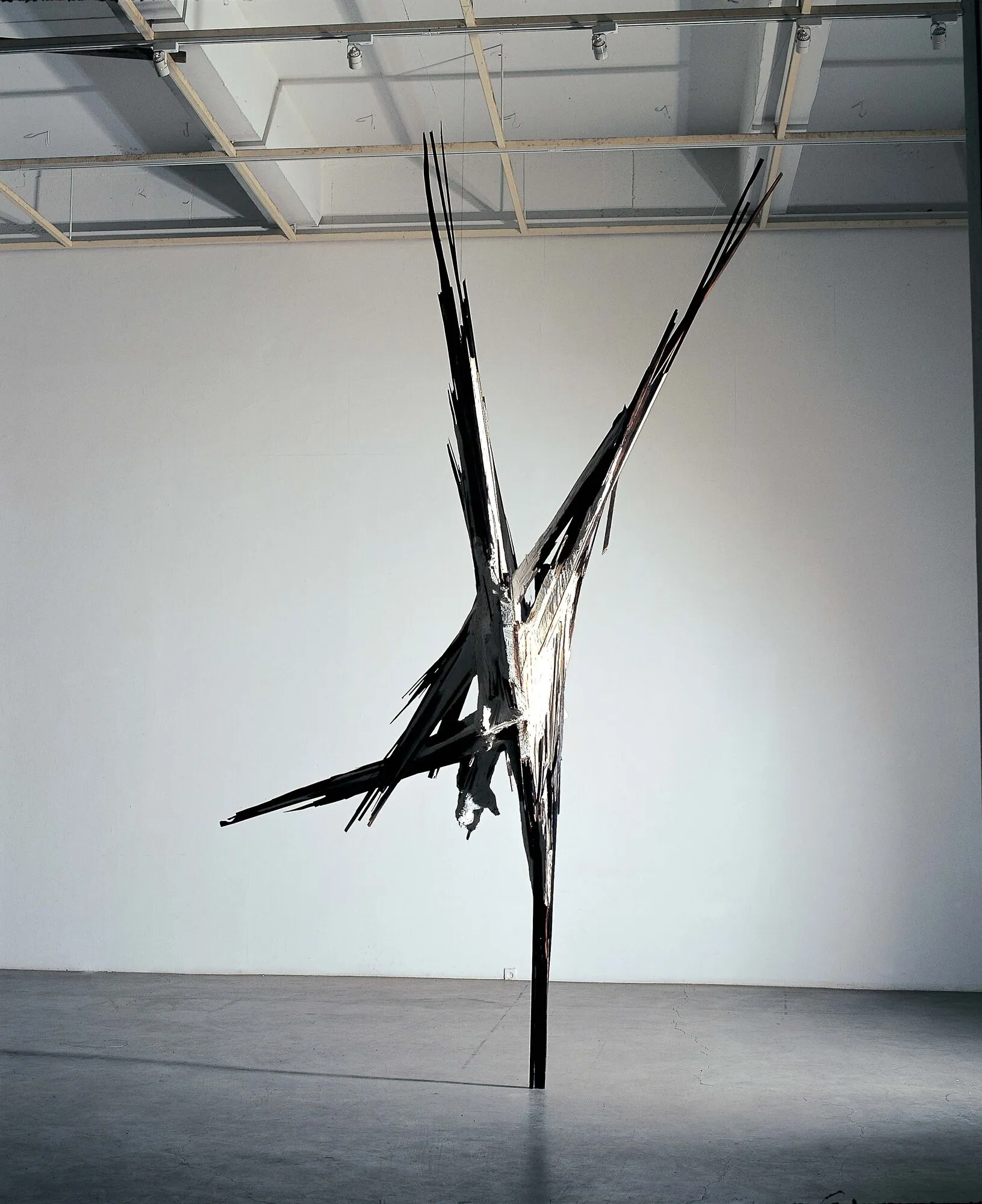 A man standing upside down, railroad tie, plaster, 415x166x56cm, 2000